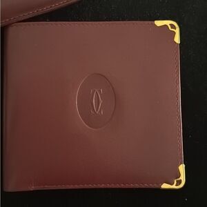 Never used Cartier red burgundy wallet comes with original box